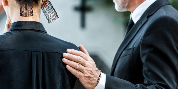 cropped-view-of-man-touching-woman-on-funeral-WXHCDM2-min
