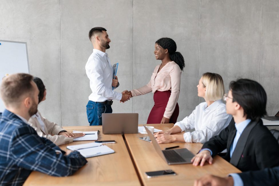 businessman-and-businesswoman-handshaking-after-ne-2023-11-27-04-53-06-utc