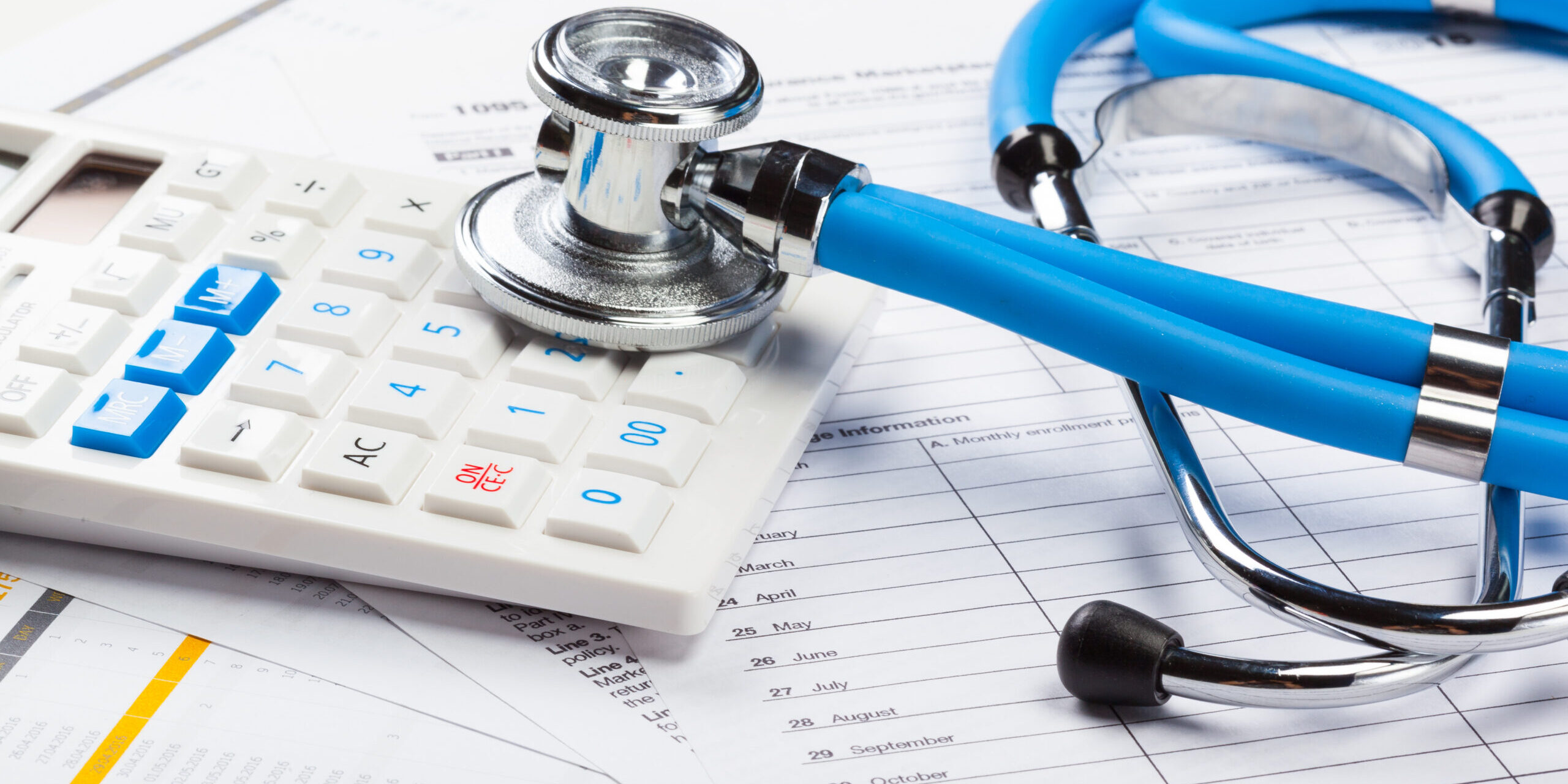 Health care costs. Stethoscope and calculator