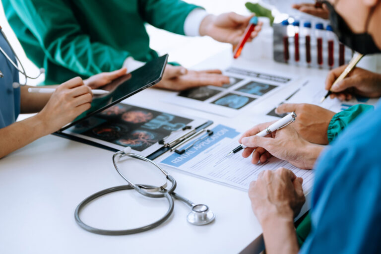 Medical team having a meeting with doctors in white lab coats an
